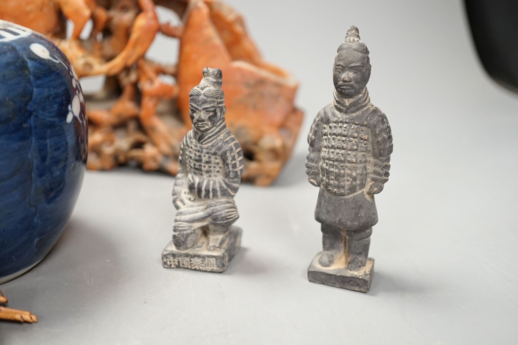 A Chinese carving of a deity, 32cm, a prunus jar, miniature vase, etc.